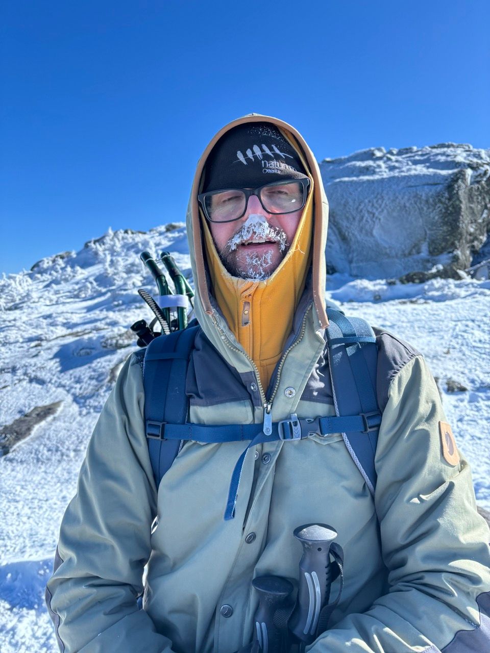 Handsome man hiking with frozen snot in his face
